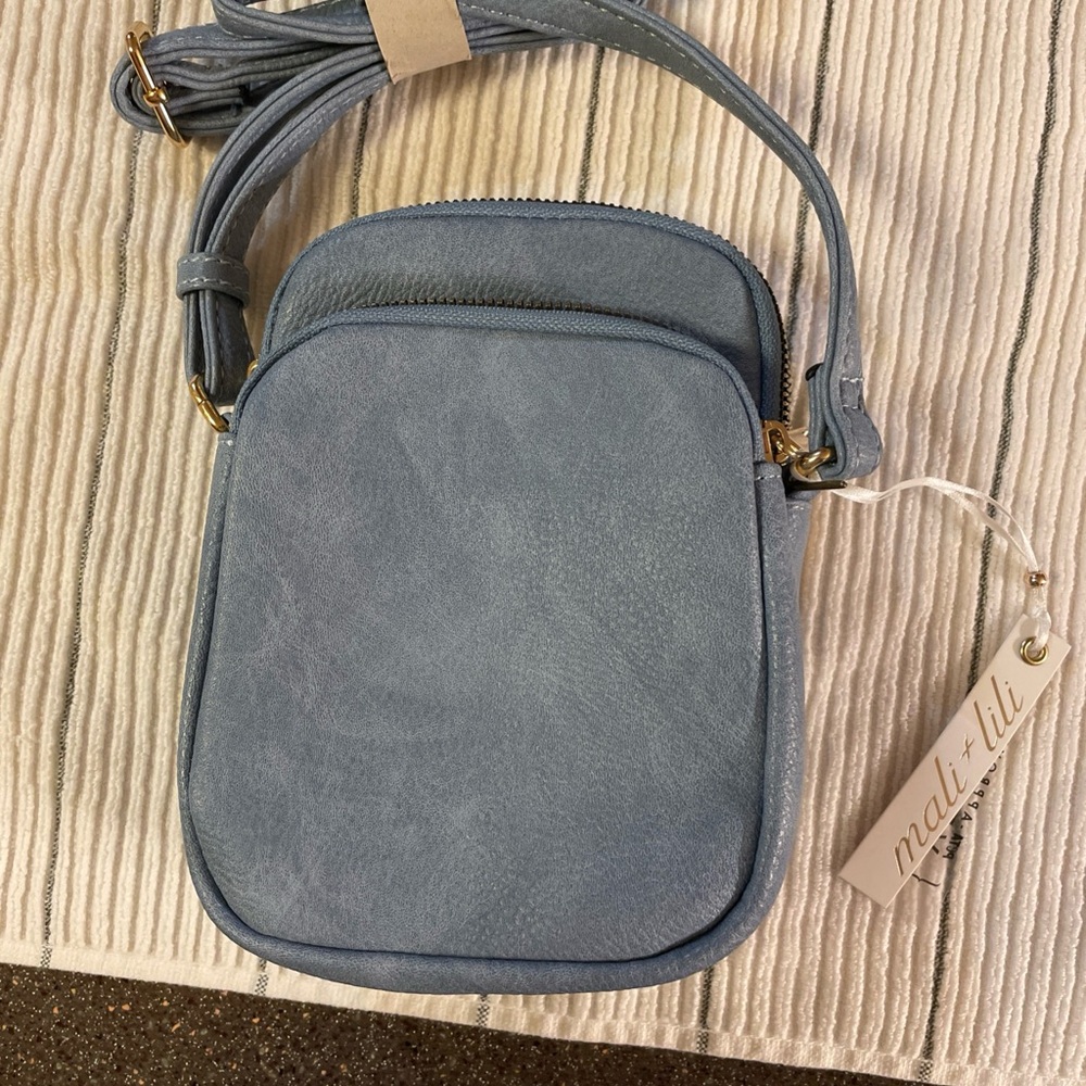 This is a Mali+Lili blue vegan leather crossbody bag.